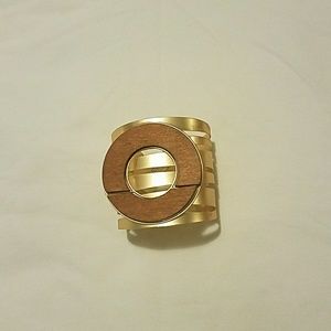 Gold bracelet with wooden top.